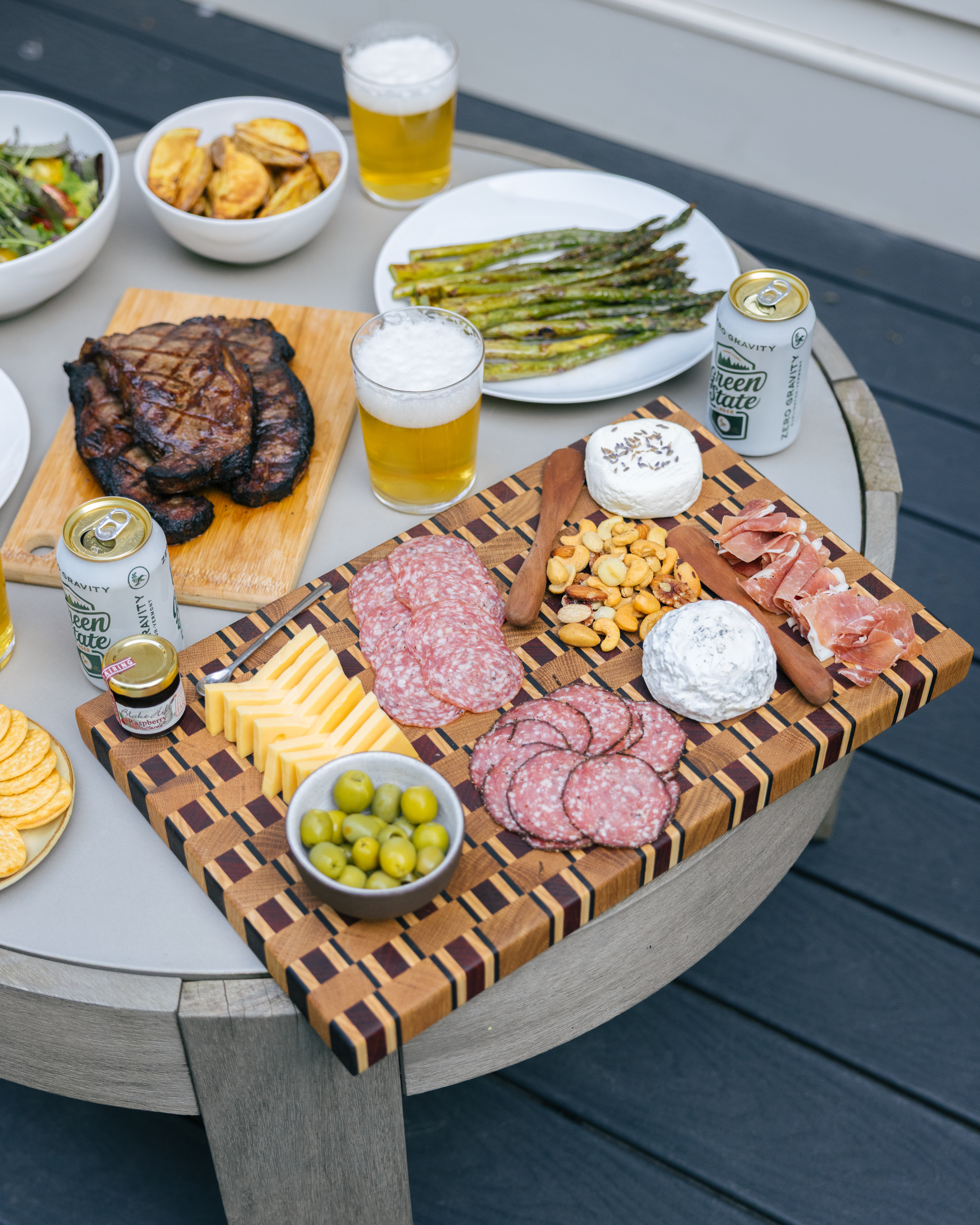 Charcuterie board and dinner spread set on an outdoor table